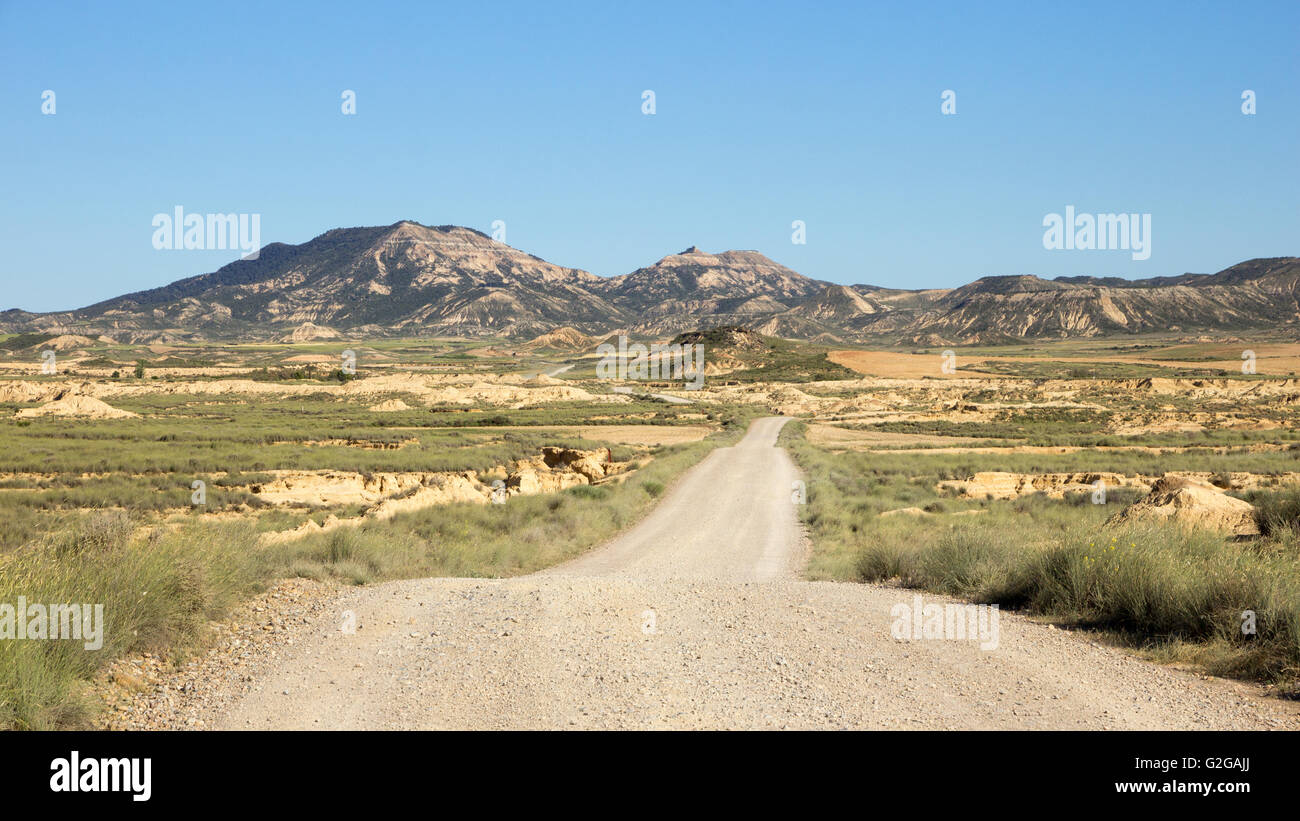 Gravel road through Bardenas Reales Natural Park. Navarre, Spain Stock Photo