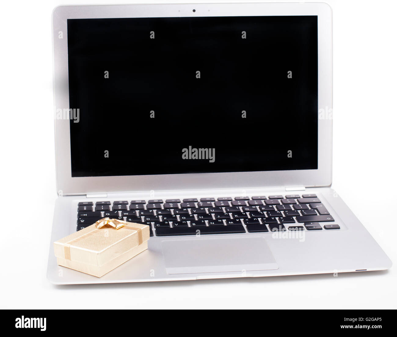 Golden Box Computer Golden gift box on silver color computer with black blank screen ...