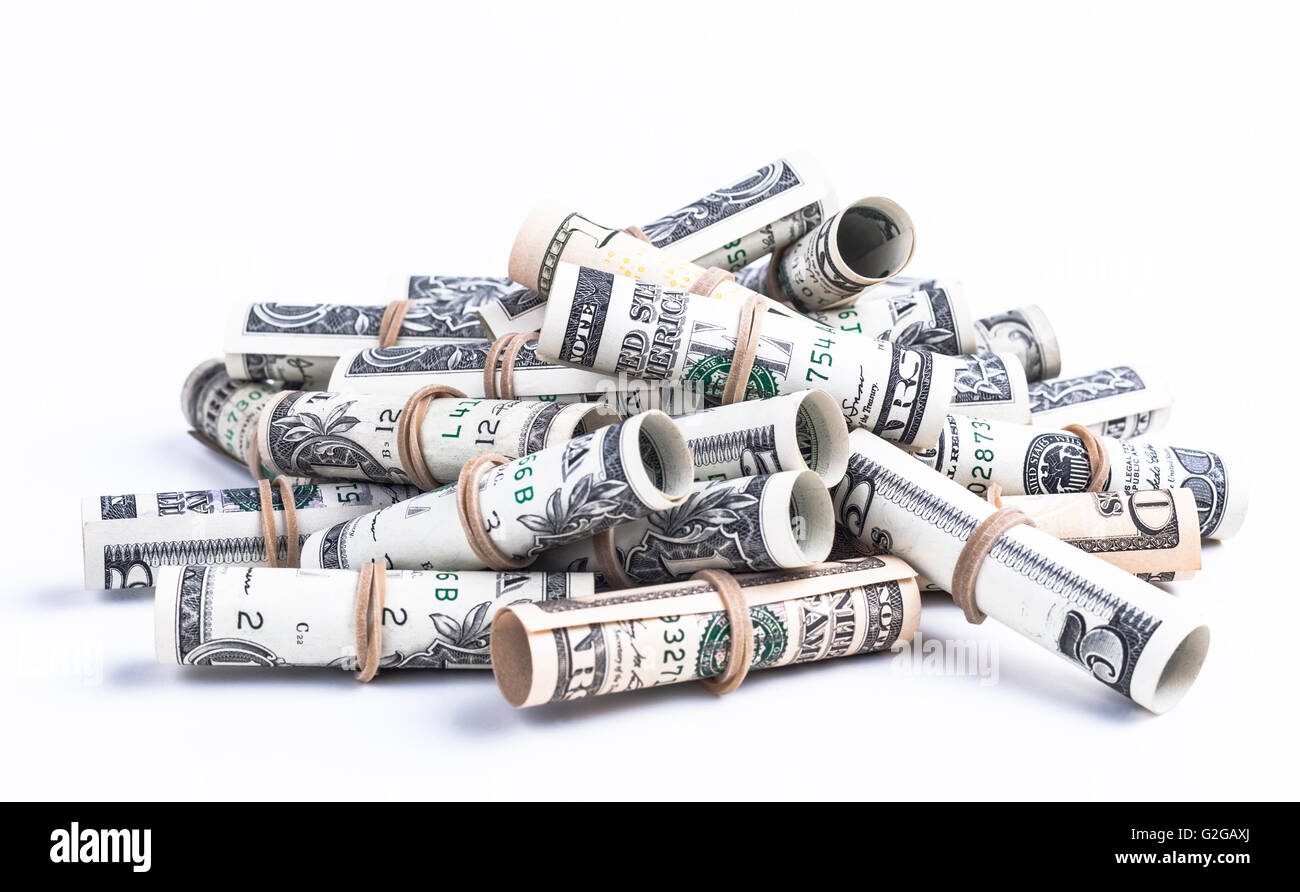 Pile of rolled dollars with elastic band isolaten on white background Stock Photo