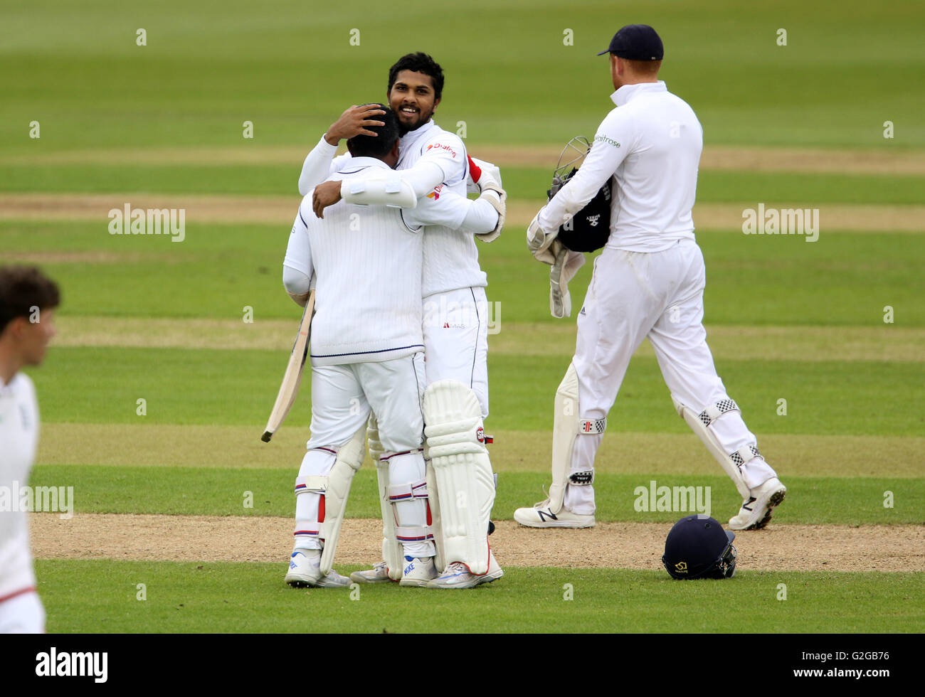 Sri Lanka's Dinesh Chandimal celebrates his 100 with team-mate Rangana Herath during day four of the Investec Second Test Match at the Emirates Riverside, Chester-Le-Street. Stock Photo