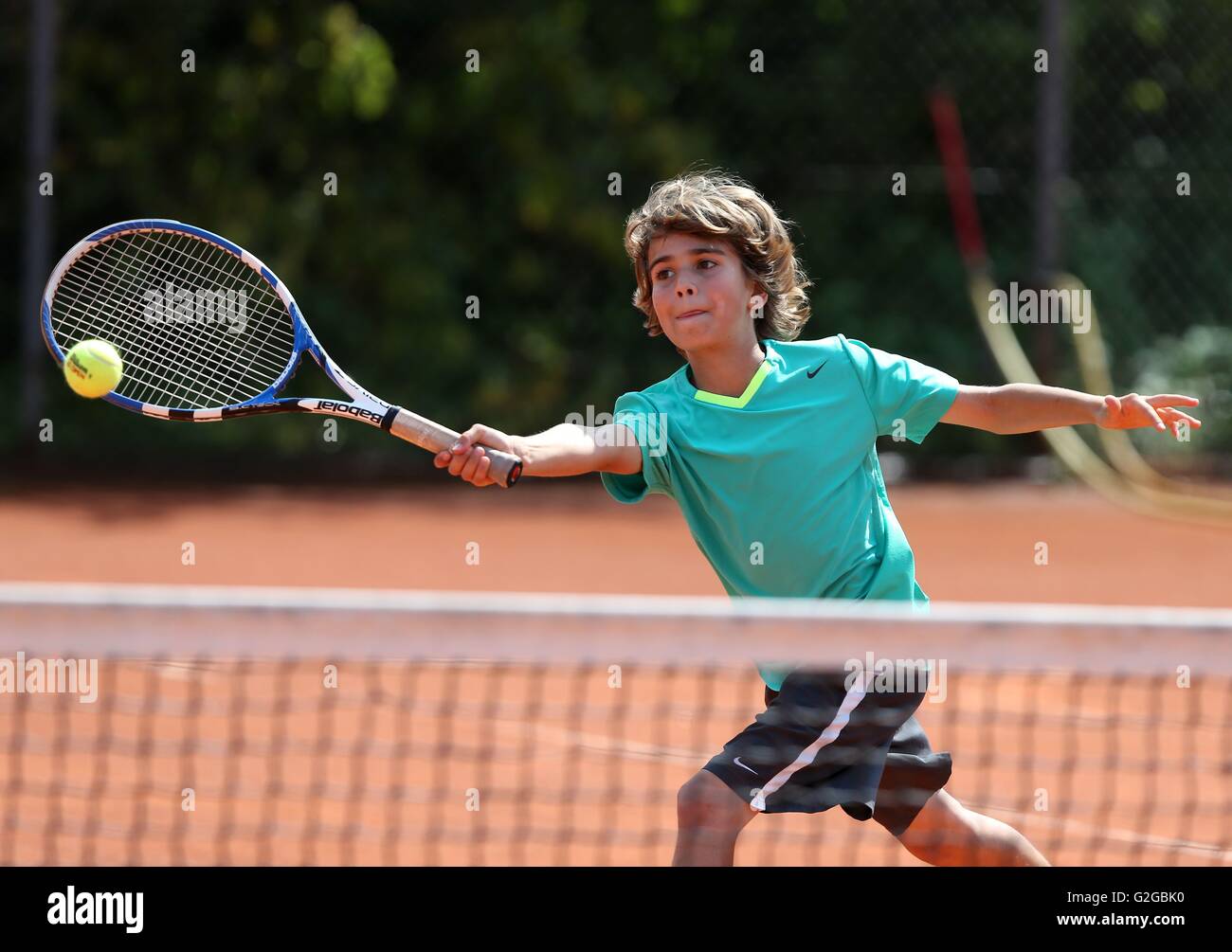 Boy, 12, playing tennis, hitting a forehand, Munich, Upper Bavaria, Bavaria, Germany Stock Photo