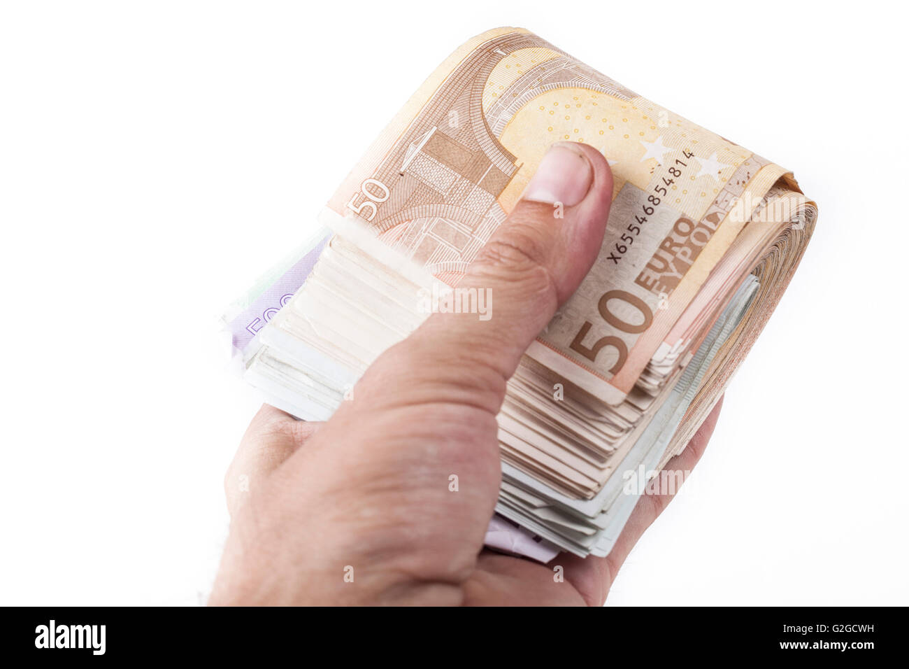 Man hand holding a bunch of euro banknotes isolated on white background ...