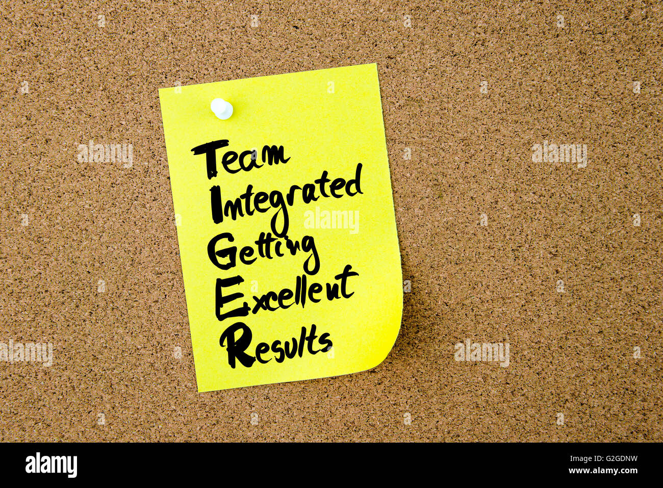 Business Acronym TIGER Team Integrated Getting Excellent Results written on yellow paper note pinned on cork board Stock Photo