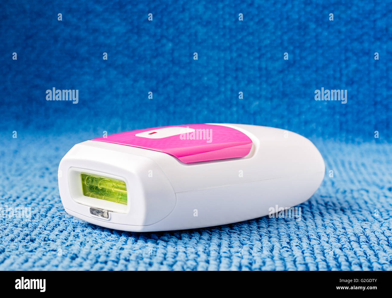 IPL hair removal epilator on a light blue towel. Stock Photo