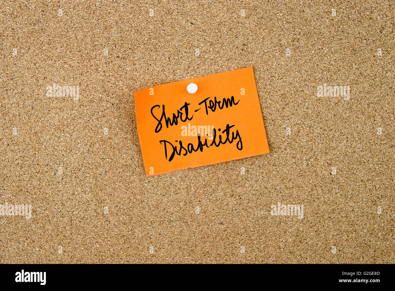 Short Term Disability written on orange paper note pinned on cork board with white thumbtacks, copy space available Stock Photo