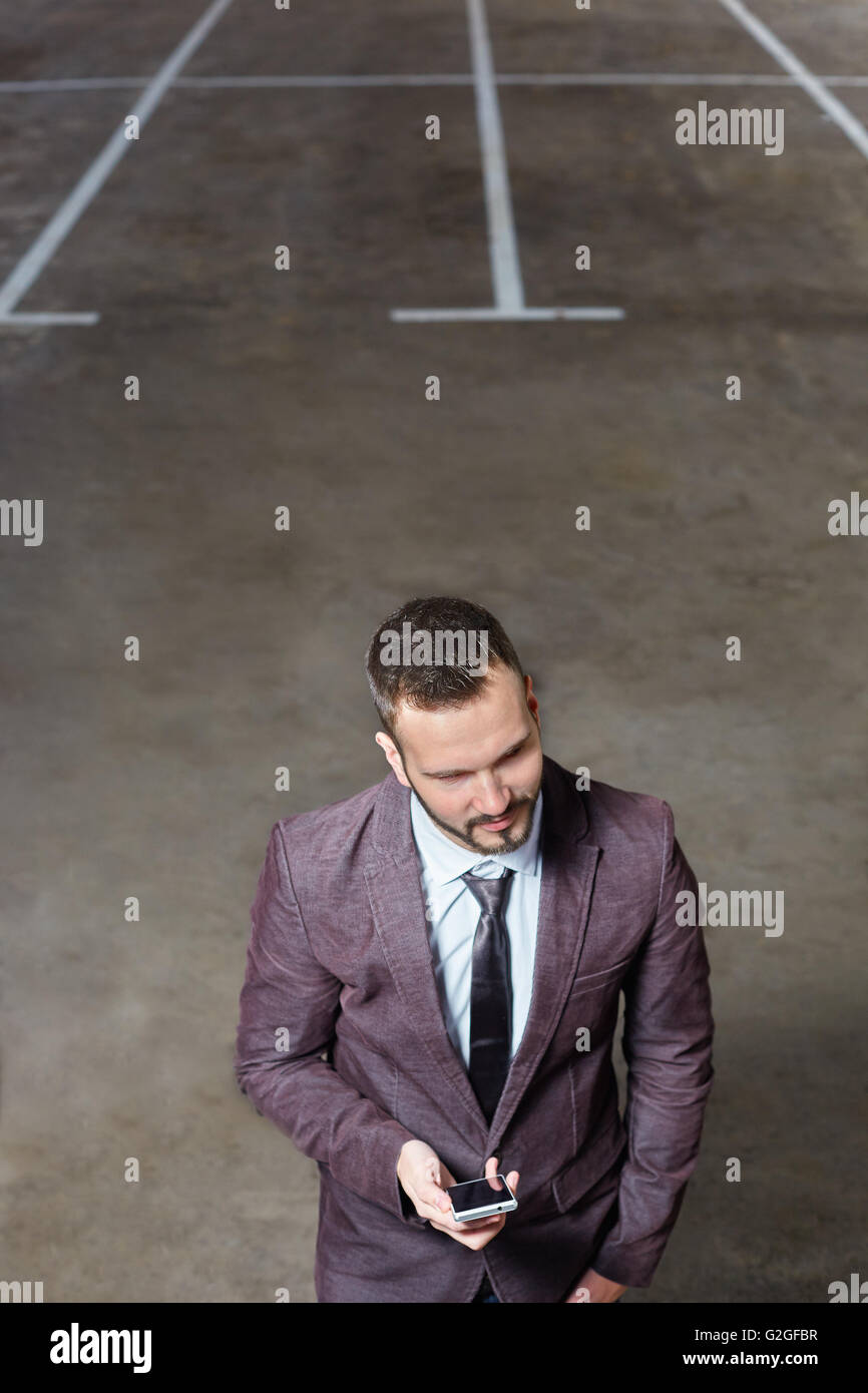 Smiling business man standing outside office building Stock Photo - Alamy