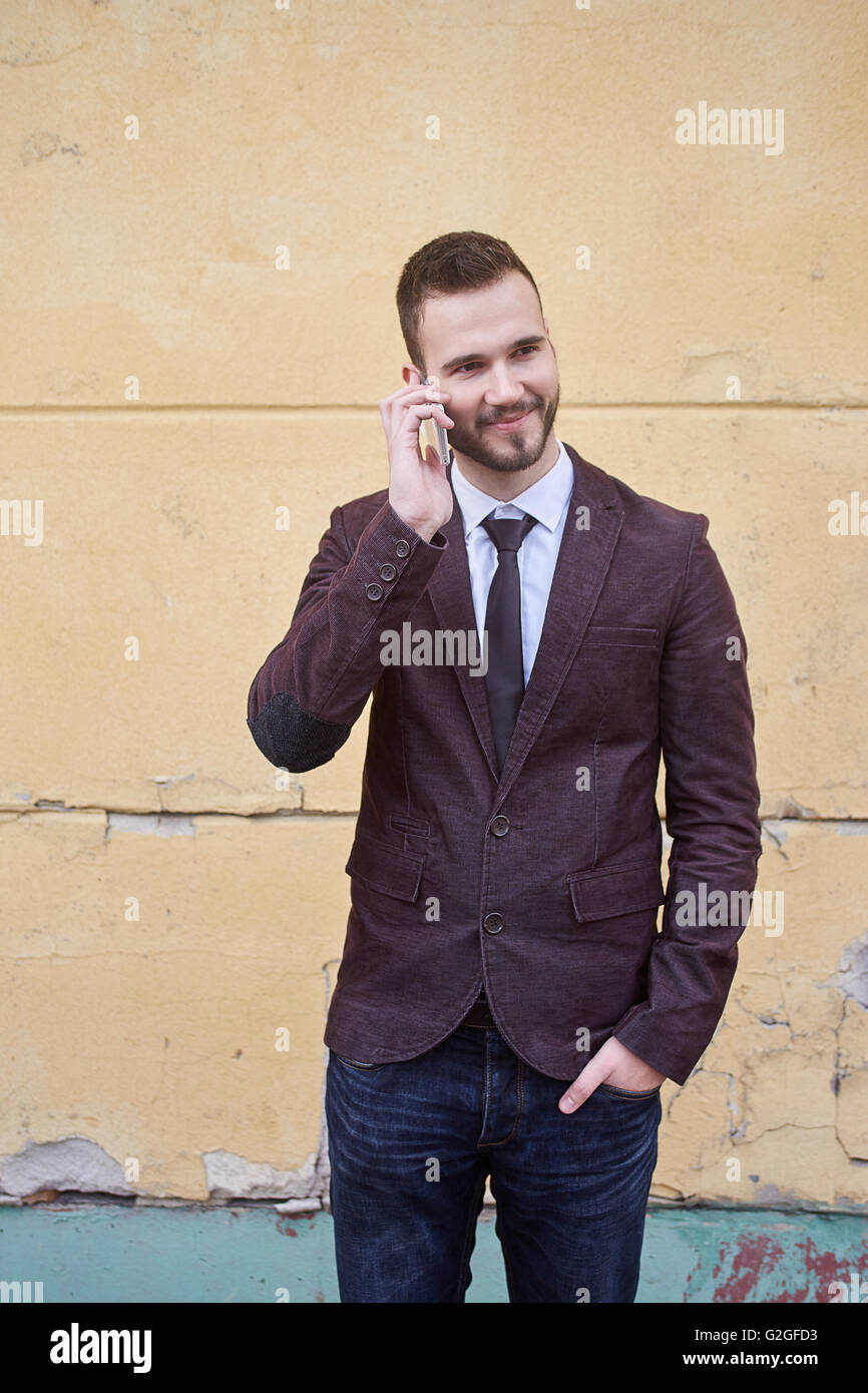 Smiling business man standing outside office building Stock Photo - Alamy