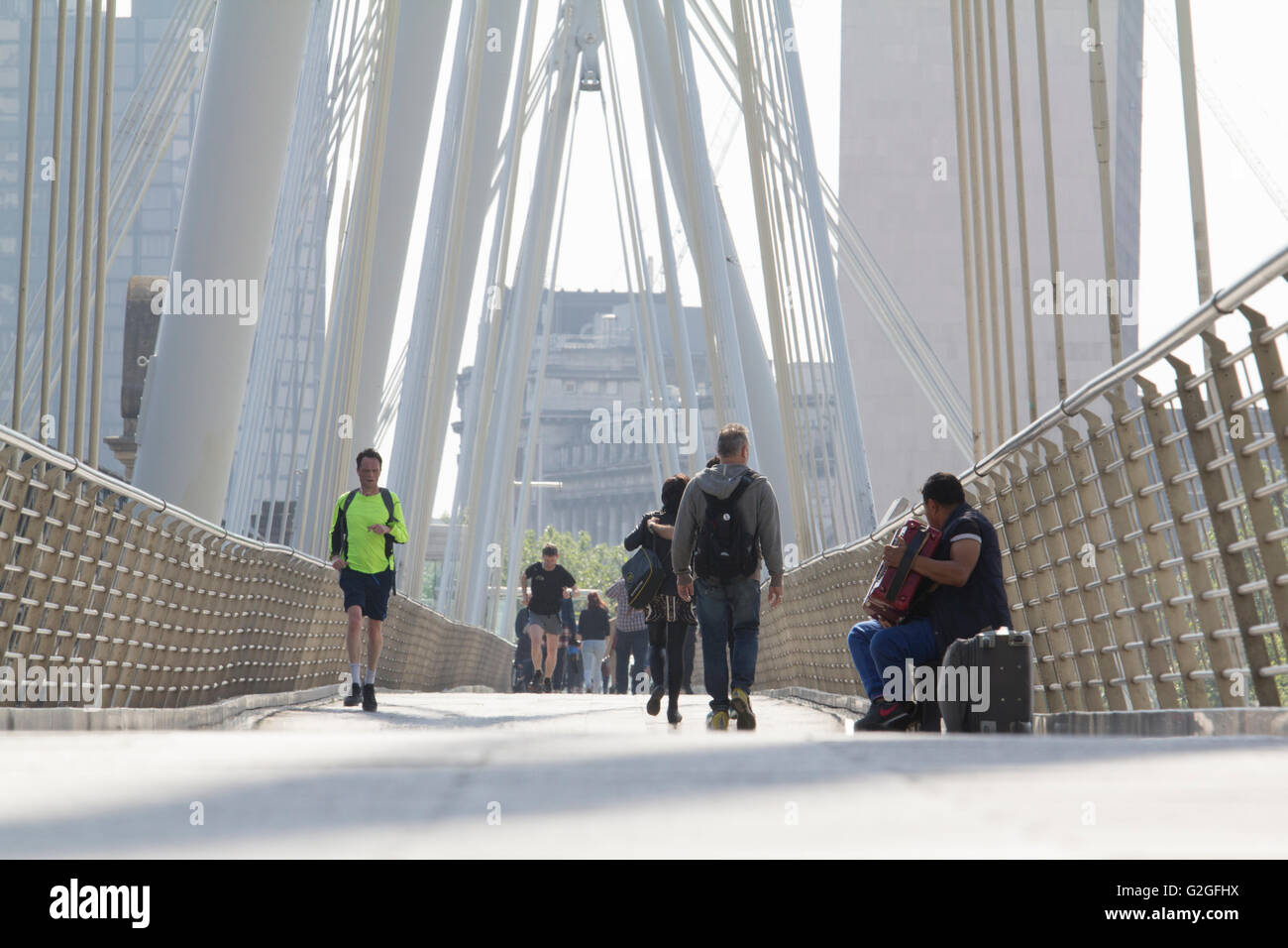 Golden Jubilee Bridge, London, UK, with busker Stock Photo