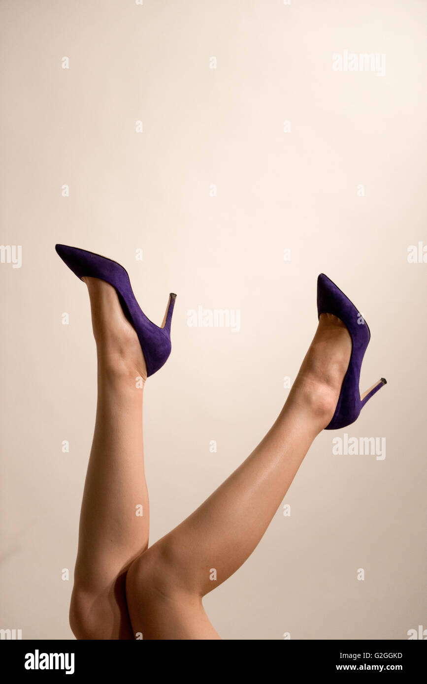 Young Adult Woman's Legs with High Heel Shoes in Air Stock Photo - Alamy