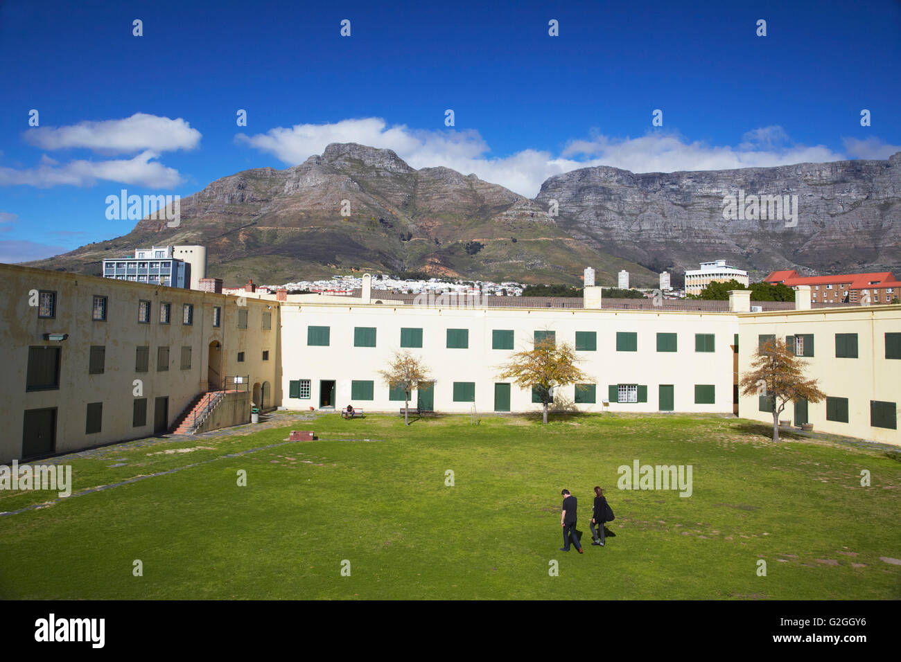 People walking across courtyard of Castle of Good Hope with Table Mountain in background, City Bowl, Cape Town, Western Cape, So Stock Photo