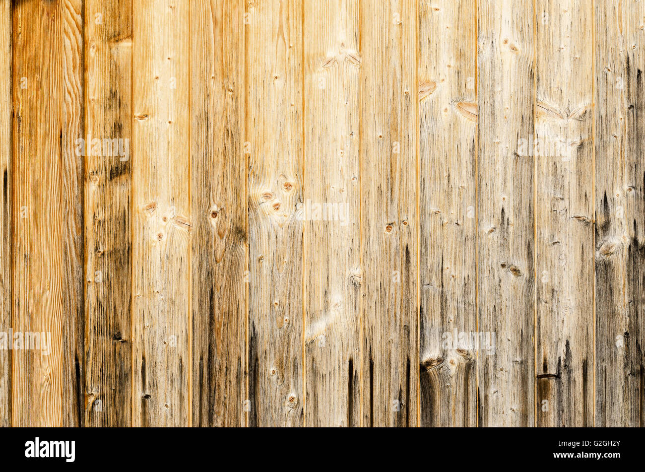 Old planked wood used as background. Wood panelling. Single planks are nailed to one surface. Photo. Stock Photo