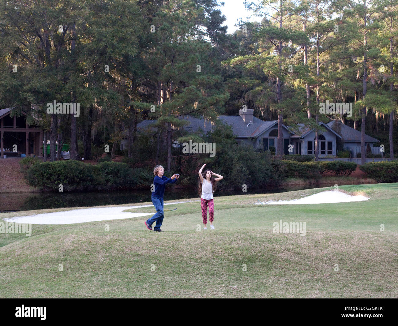 kids playing with toy drone on golf course in South Carolina Stock Photo