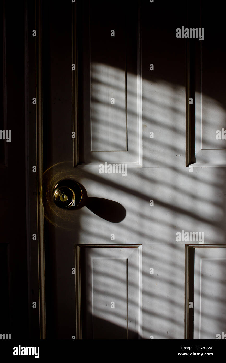 Door and Knob with Shadow, Close-Up Stock Photo