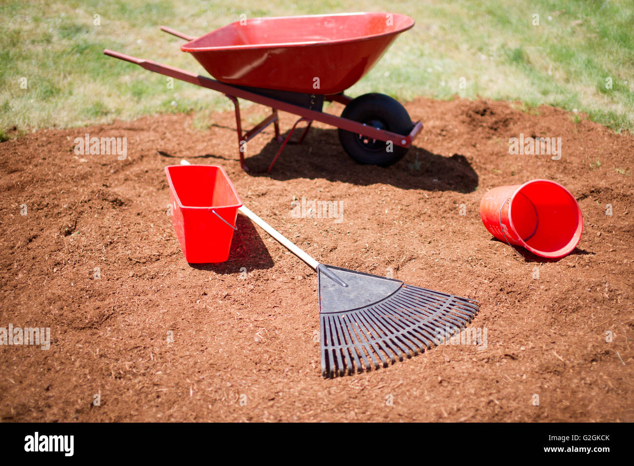 Wheelbarrow, Buckets and Rake on Pile of Mulch Stock Photo Alamy