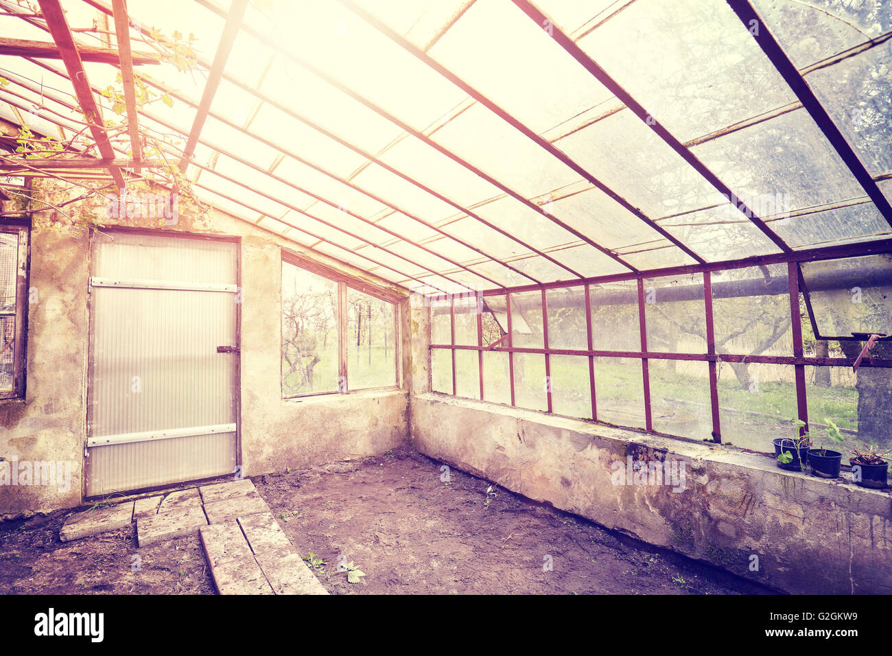 Vintage toned wide angle picture of an old empty glasshouse. Stock Photo