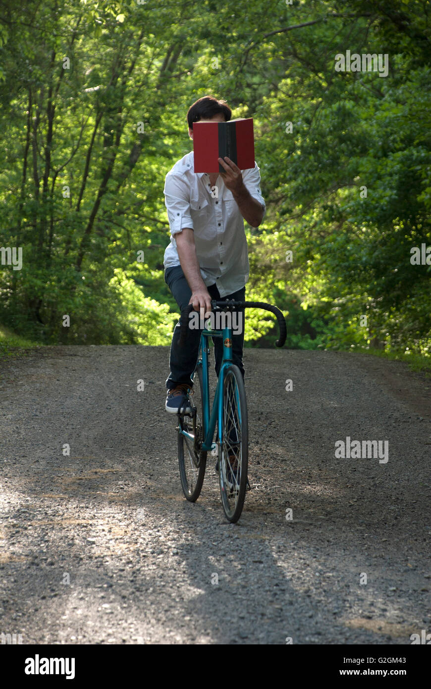 Young Adult Man Reading Bicycle on Bicycle Stock Photo Alamy