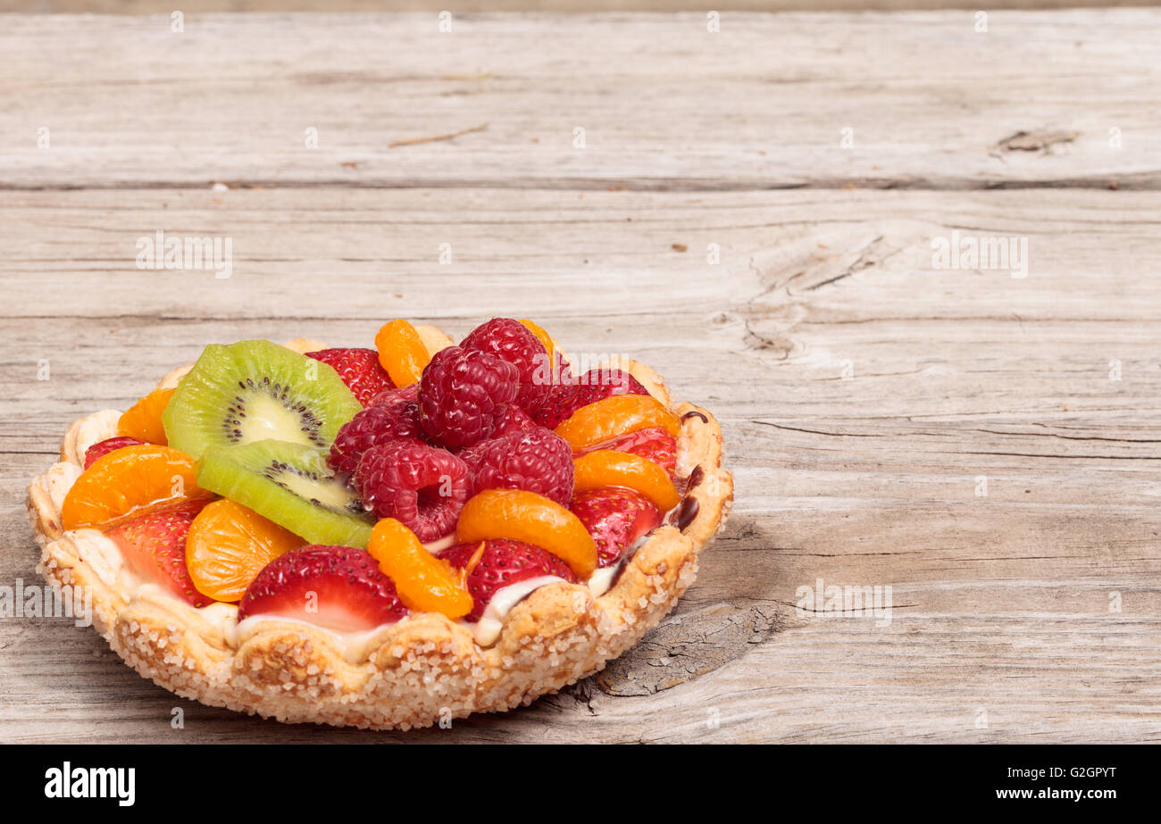 Fruit tart with a yellow custard, ladyfinger cookie shell crust