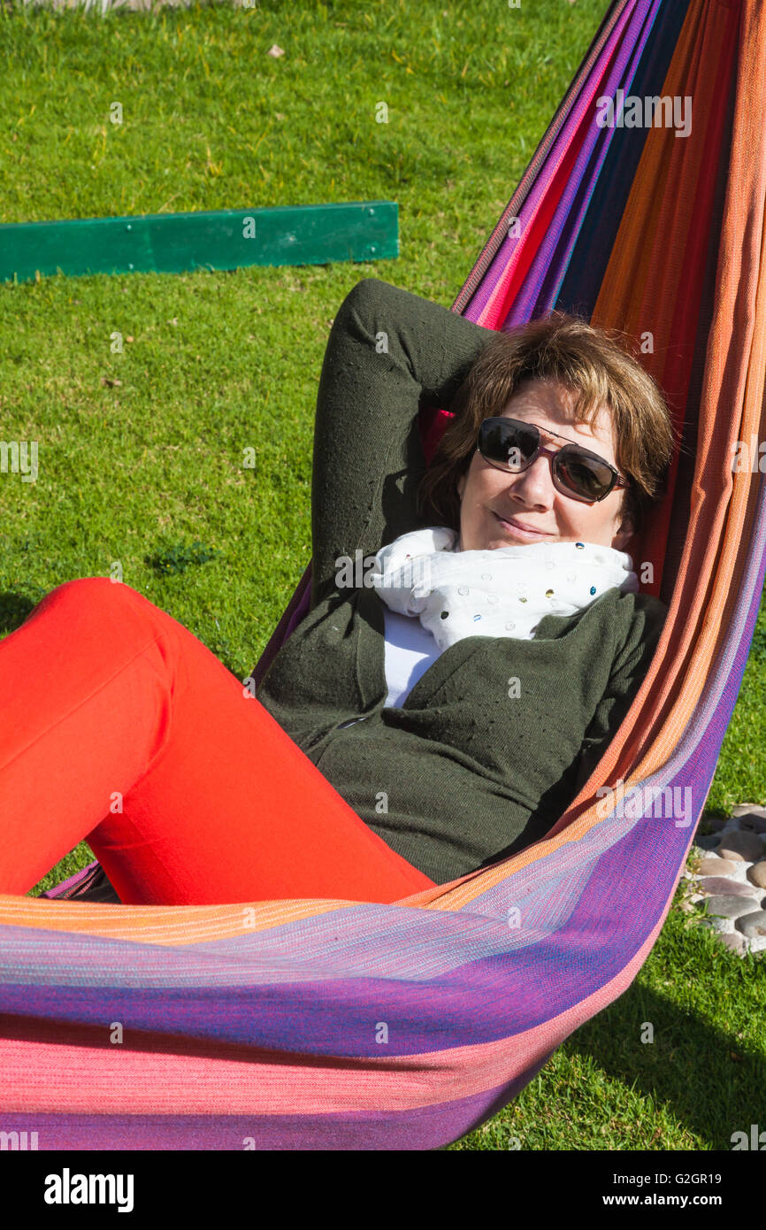 Woman relaxing in a hammock on a sunny day Stock Photo
