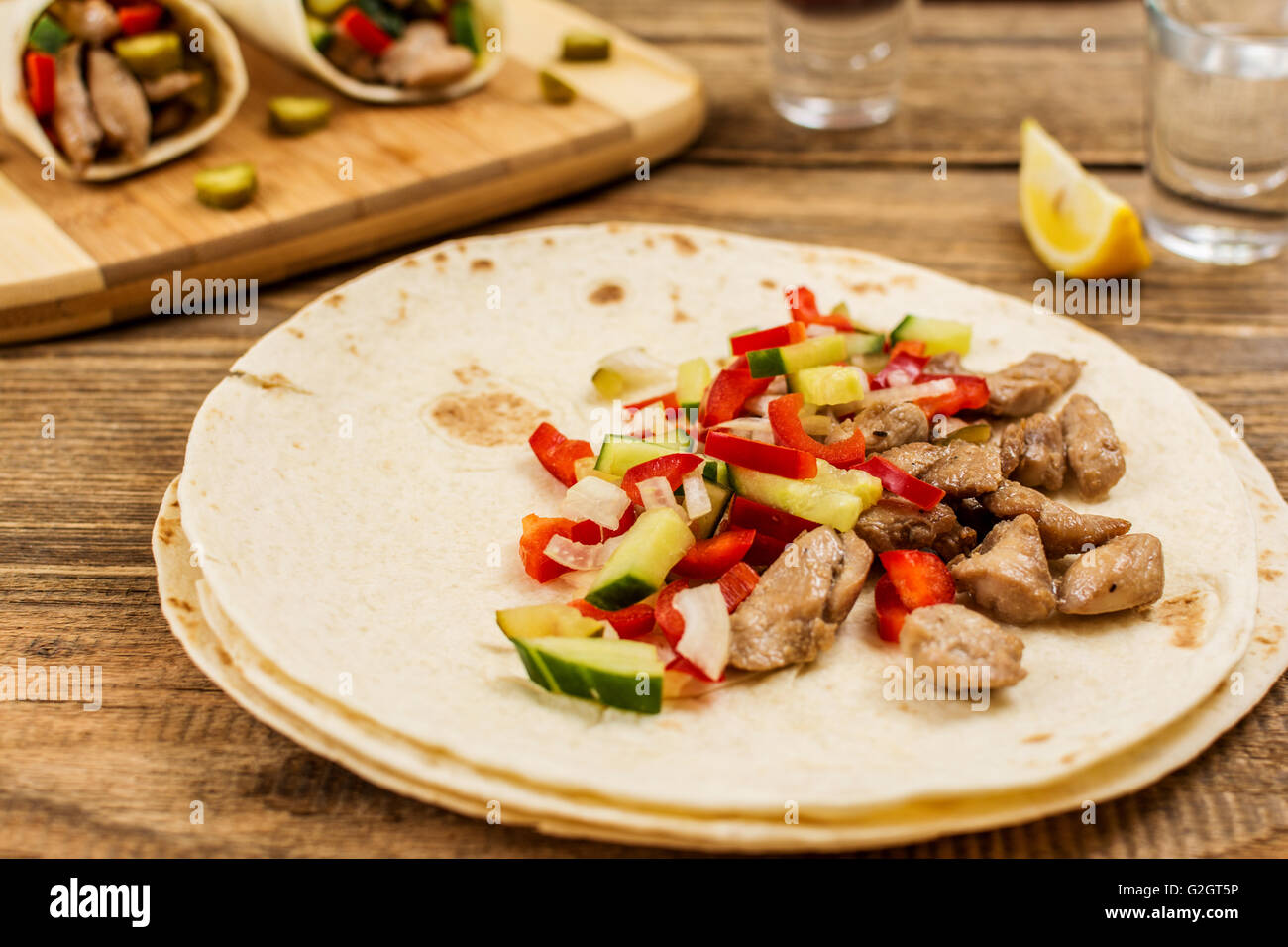 Traditional mexican tortila wrap with meat and vegetables Stock Photo