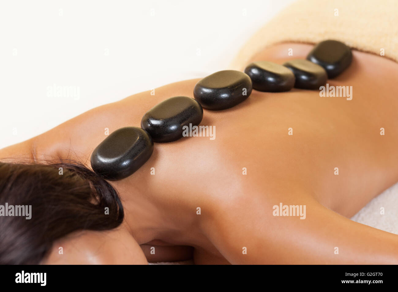 Spa therapy procedure with stones Stock Photo