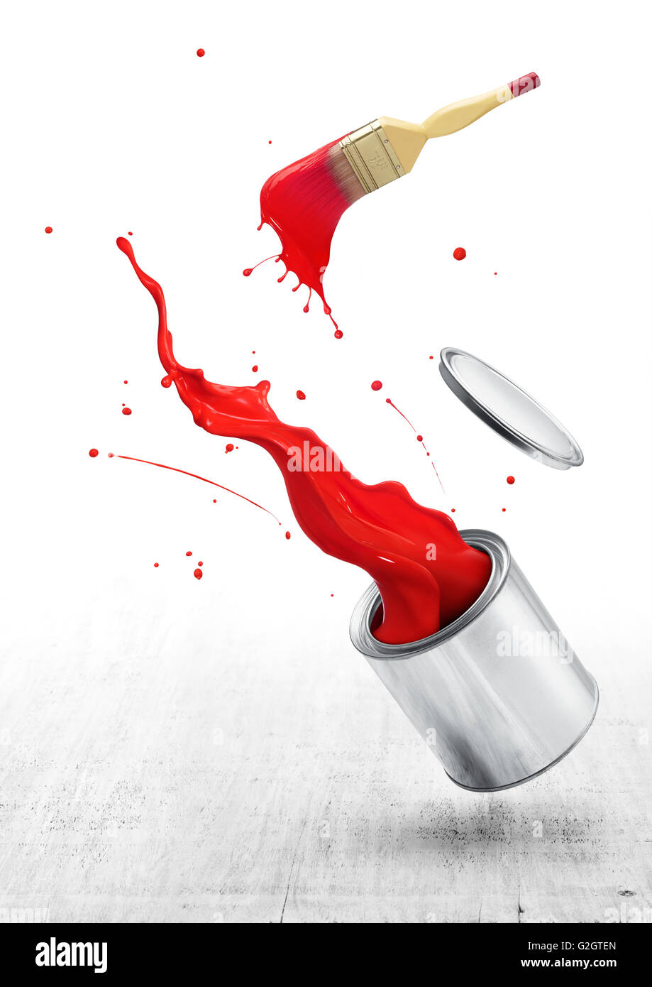 red paint splashing out from its bucket with paintbrush Stock Photo