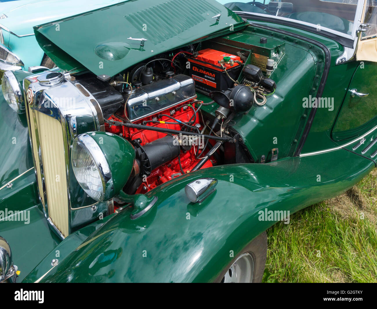 A classic British Racing Green  MG-TA roadster sports car with bonnet open to show engine Stock Photo