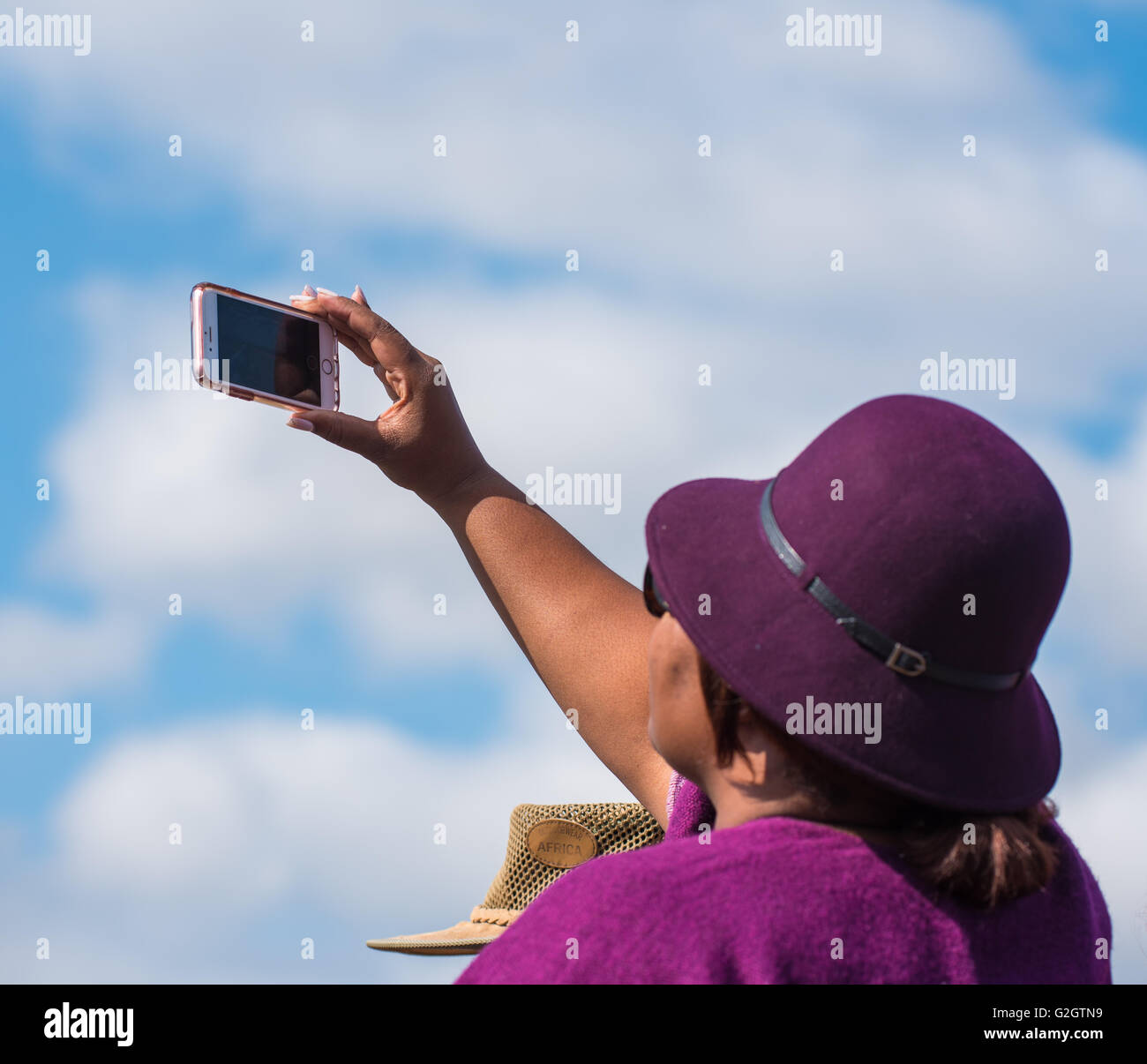 A spectator at the Lowveld Airshow taking a video with her cell phone Stock Photo