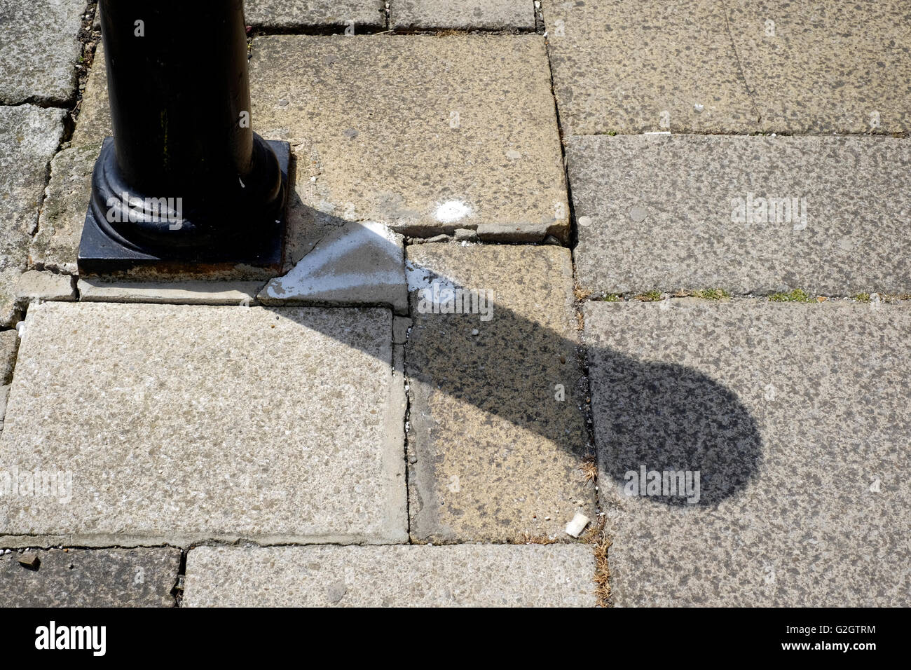 uneven paving slabs on pavement presenting hazard for pedestrians england uk Stock Photo