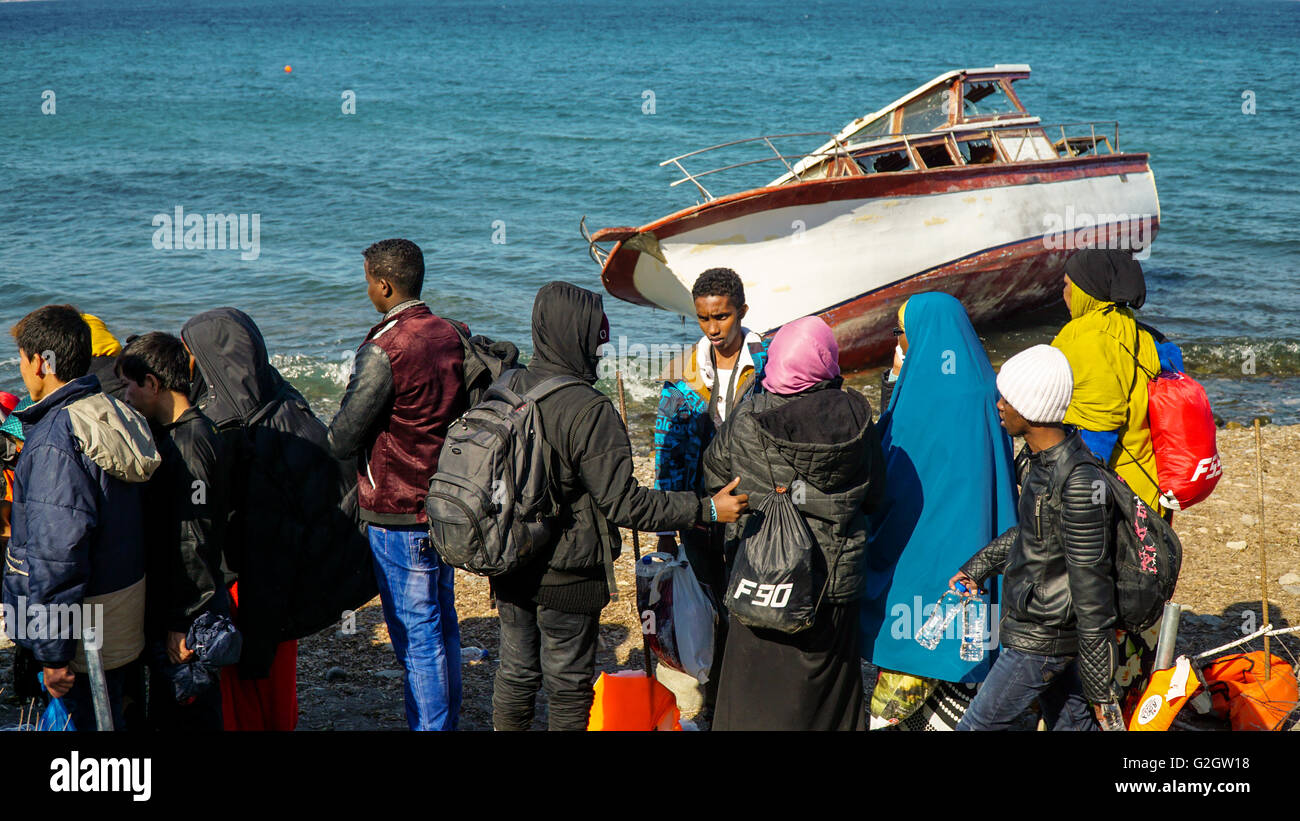 LESVOS, GREECE - October 10, 2015: Refugees just arrived from Turkey waiting for the bus to camp. Stock Photo