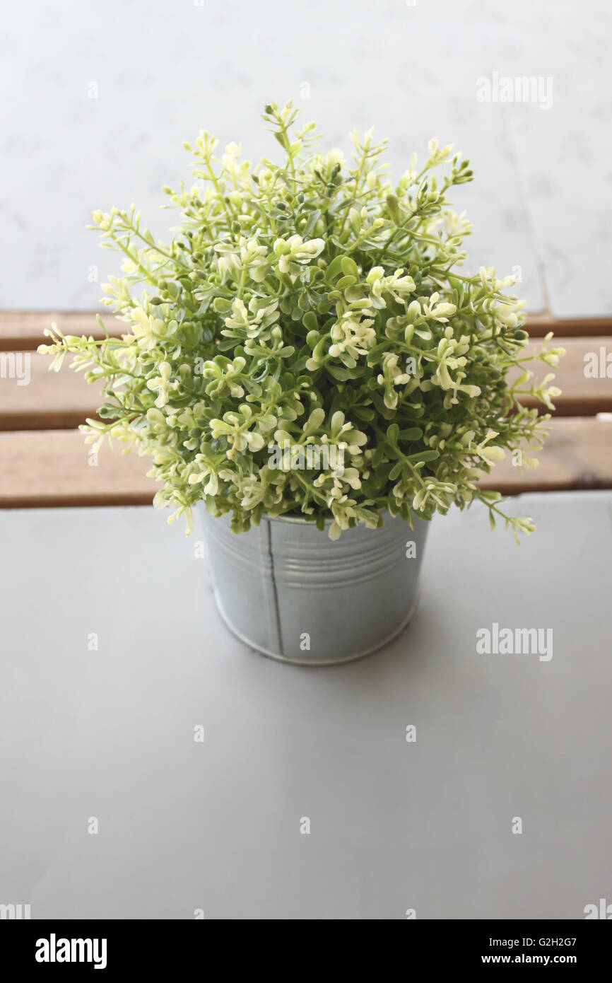 Vintage Bogus flowers in the interior of nature objects on a table. Stock Photo
