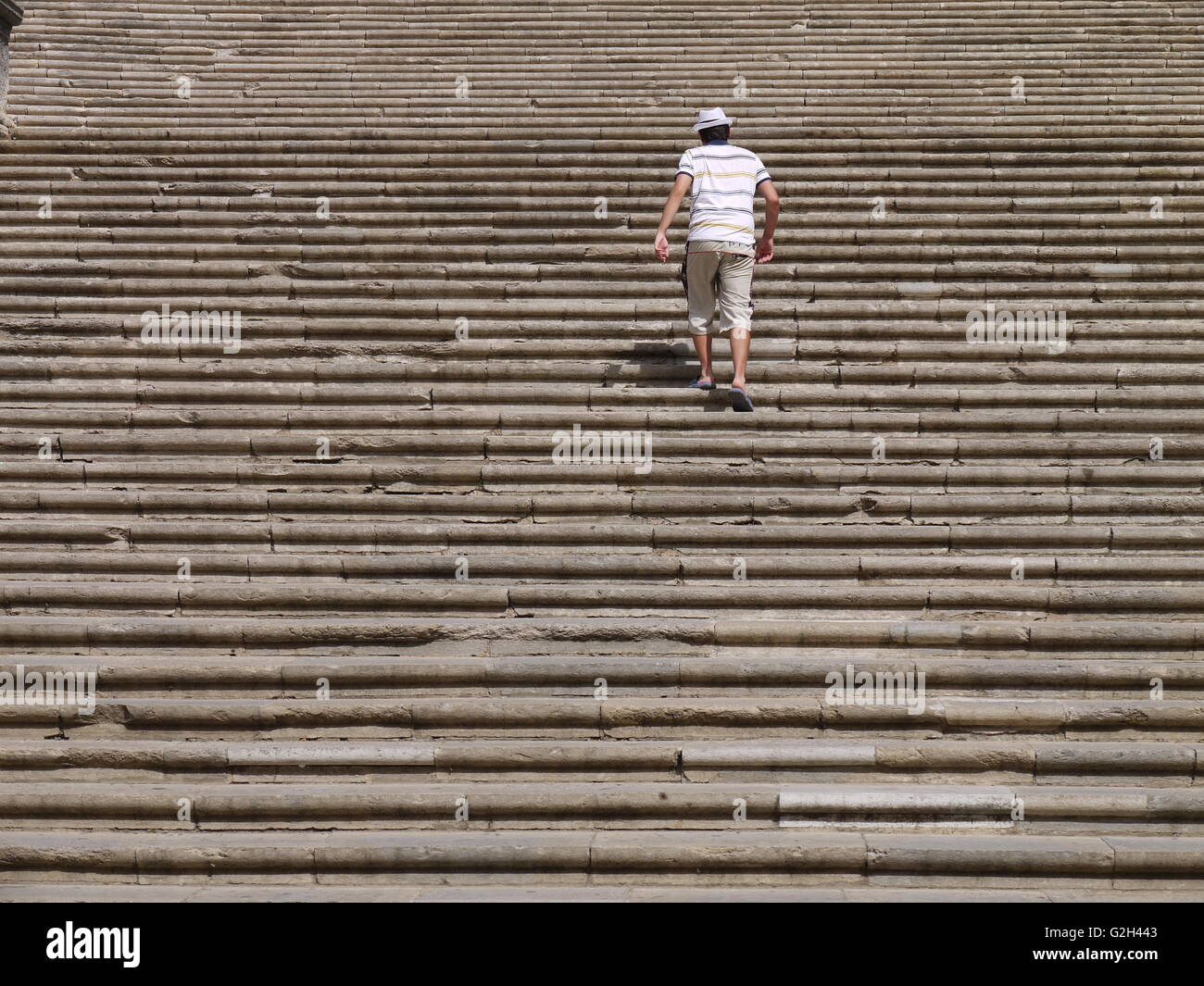 A man climbs the stairs of church in Girona, little city of Catalonia, in Spain Stock Photo
