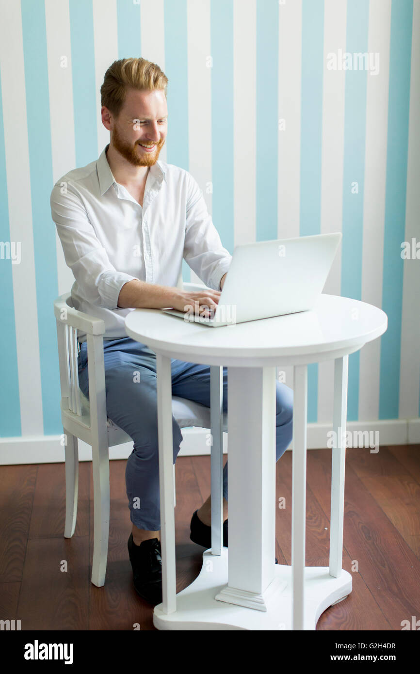 Young man sitting home hi-res stock photography and images - Alamy