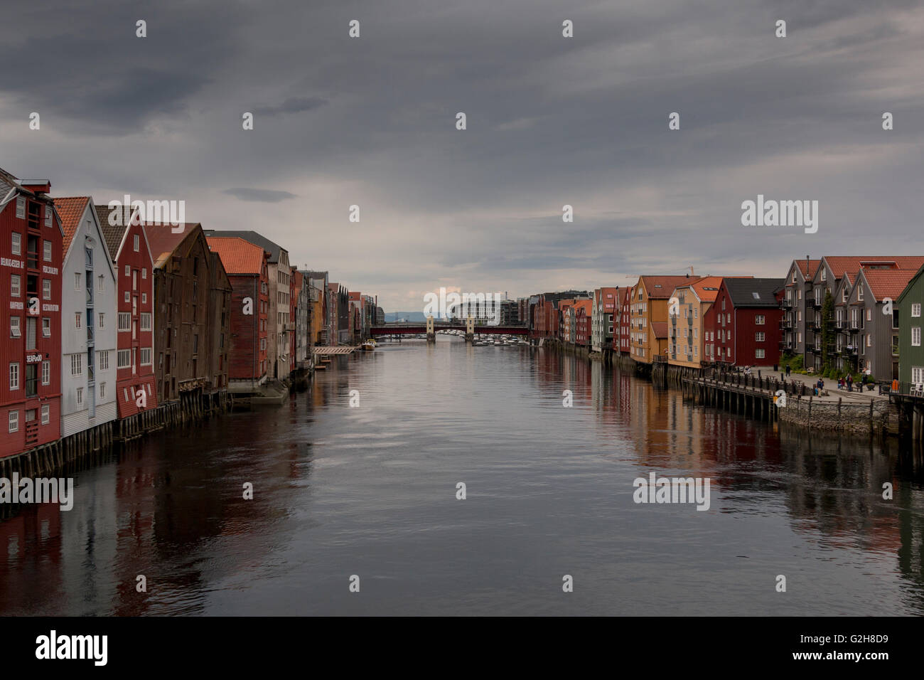 View over Nidelva river in Trondheim, Norway with historic buildings on both sides on a cloudy day Stock Photo