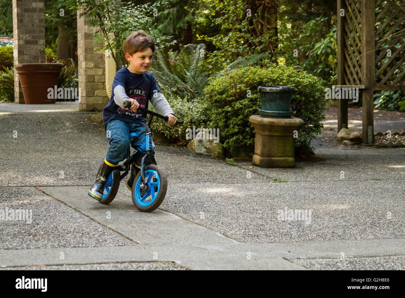 Four year old boy showing off how well he can ride his bike in Issaquah