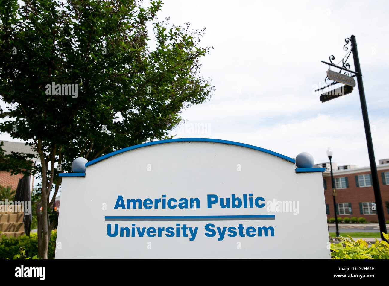 A logo sign outside of the headquarters of the American Public University System, a for-profit college, in Charles Town, West Vi Stock Photo