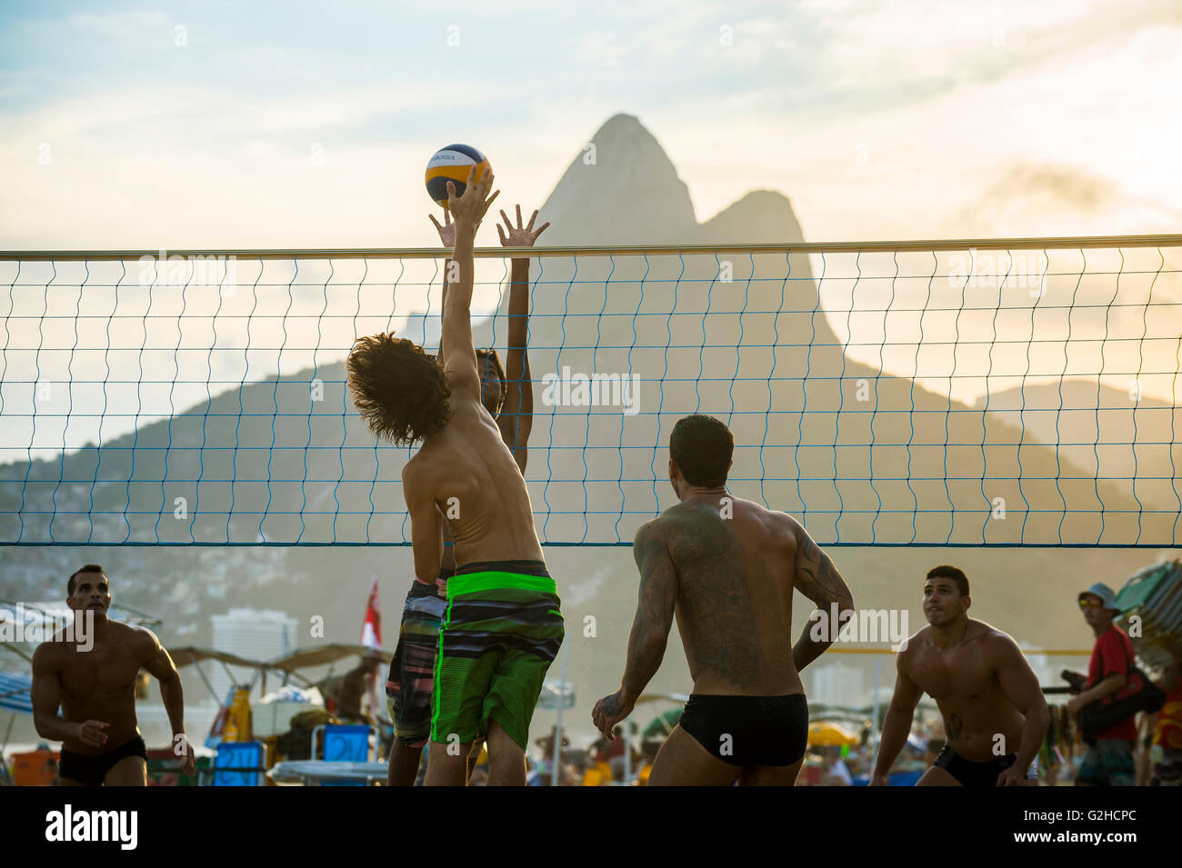 RIO DE JANEIRO - MARCH 20, 2016: Young carioca Brazilians play beach volleyball, an Olympic sport Brazil is favored to win. Stock Photo