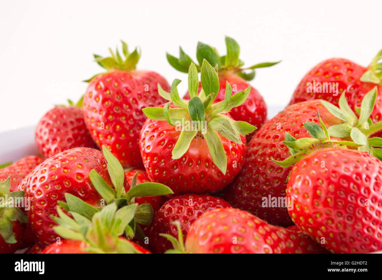 Fresh strawberries in a white bowl against white background Stock Photo ...