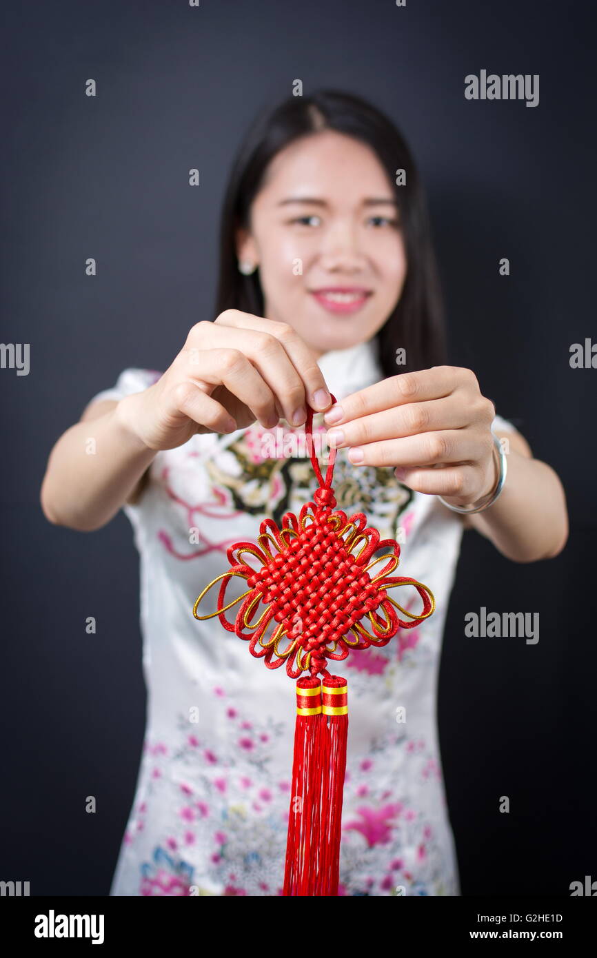 Beautiful asian woman holding a red Chinese knot Stock Photo
