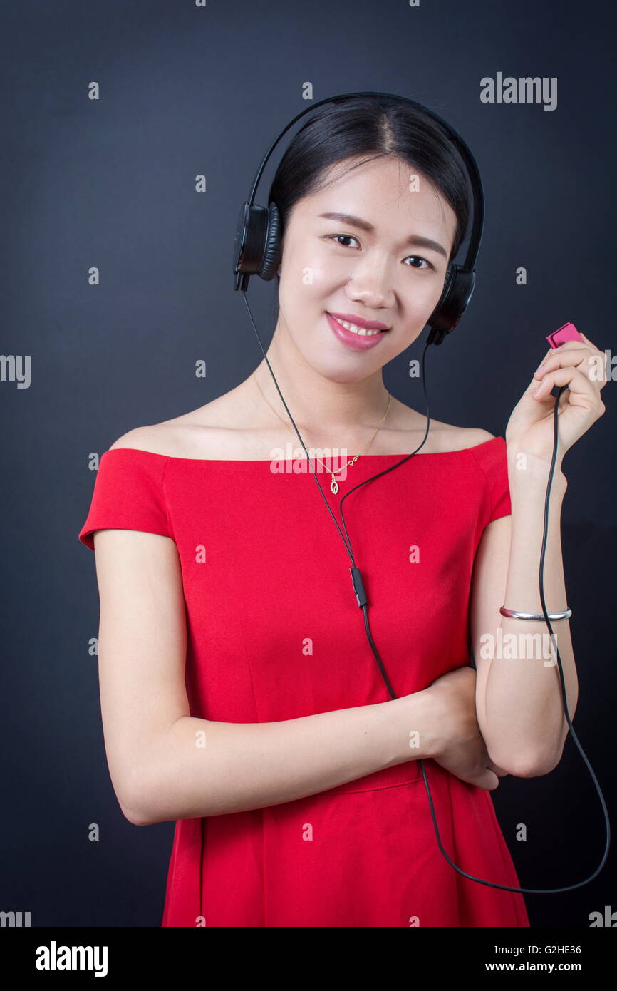 Beautiful asian woman listening to music with headphones Stock Photo
