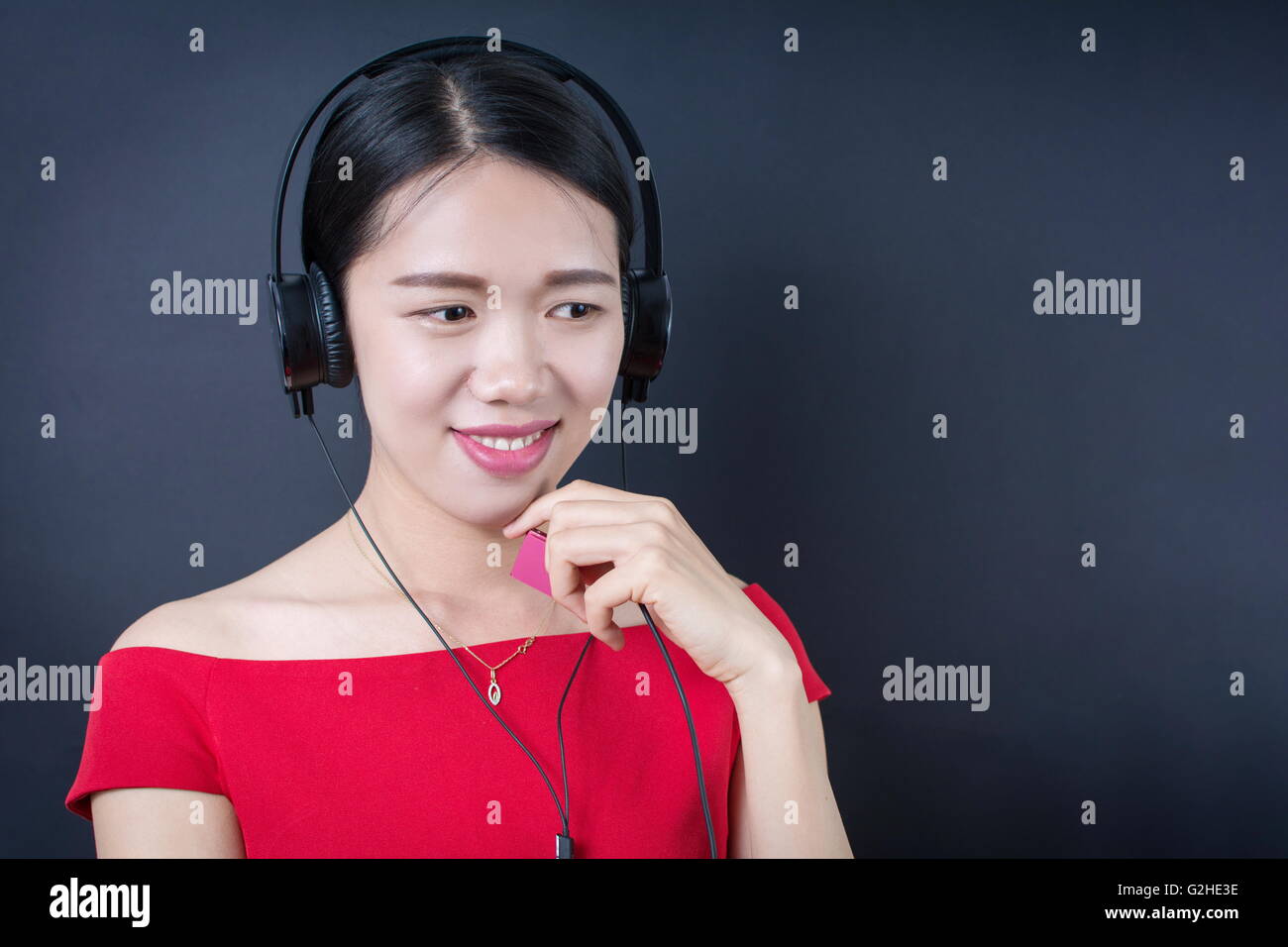 Beautiful asian woman listening to music with headphones Stock Photo