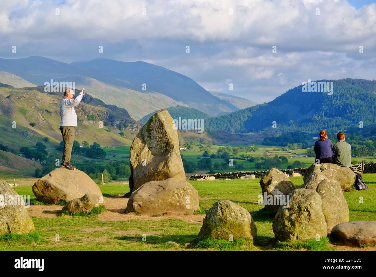Castlerigg Stone Circle, Lake District, Cumbria, UK: 30 May 2016. Visitors enjoy the view  at Castlerigg Stone Circle in the late afternoon sun on a day when crowds enjoyed a hot and suny Bank Holliday in the Lake District. Credit:  Tom Corban/Alamy Live News Stock Photo
