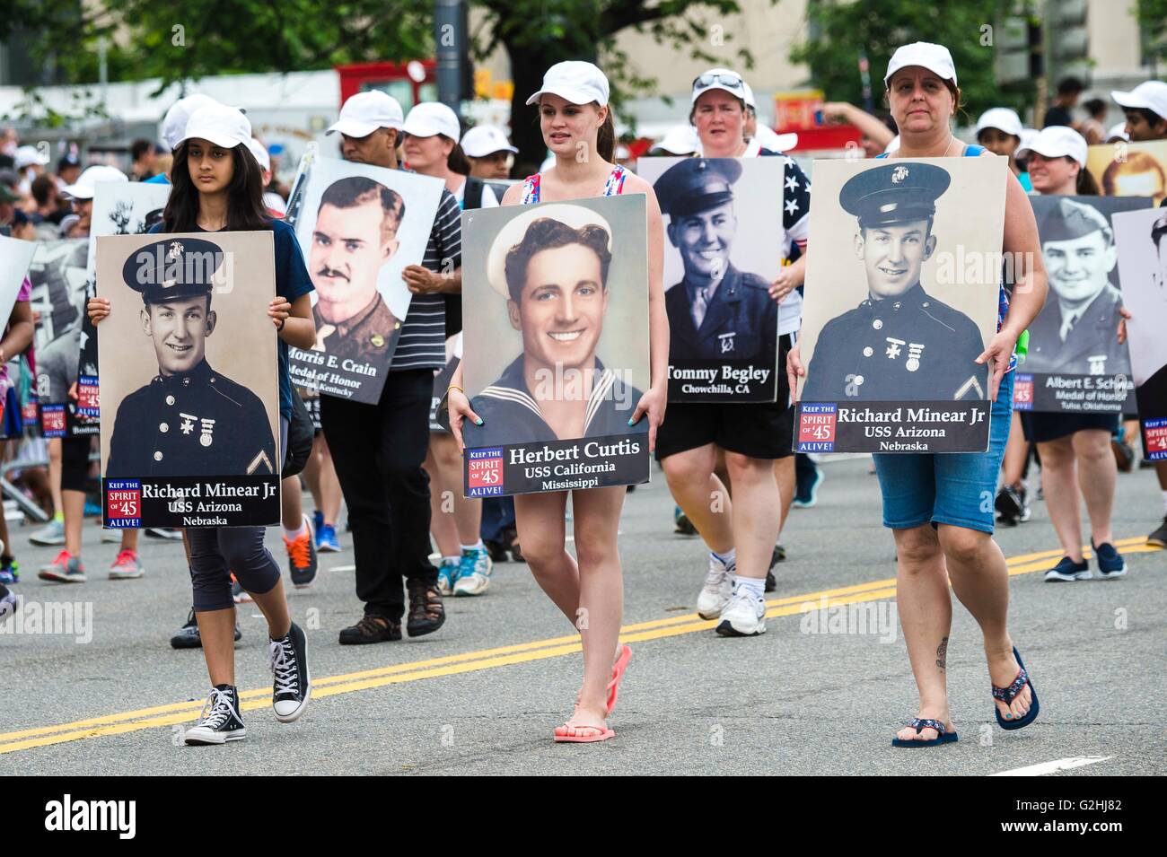 Washington DC, USA. 30th May, 2016. Holding photos of service members killed in war marchers parade down Pennsylvania Avenue during The American Veterans Center National Memorial Day Parade May 30, 2016 in Washington, DC. Credit:  Planetpix/Alamy Live News Stock Photo