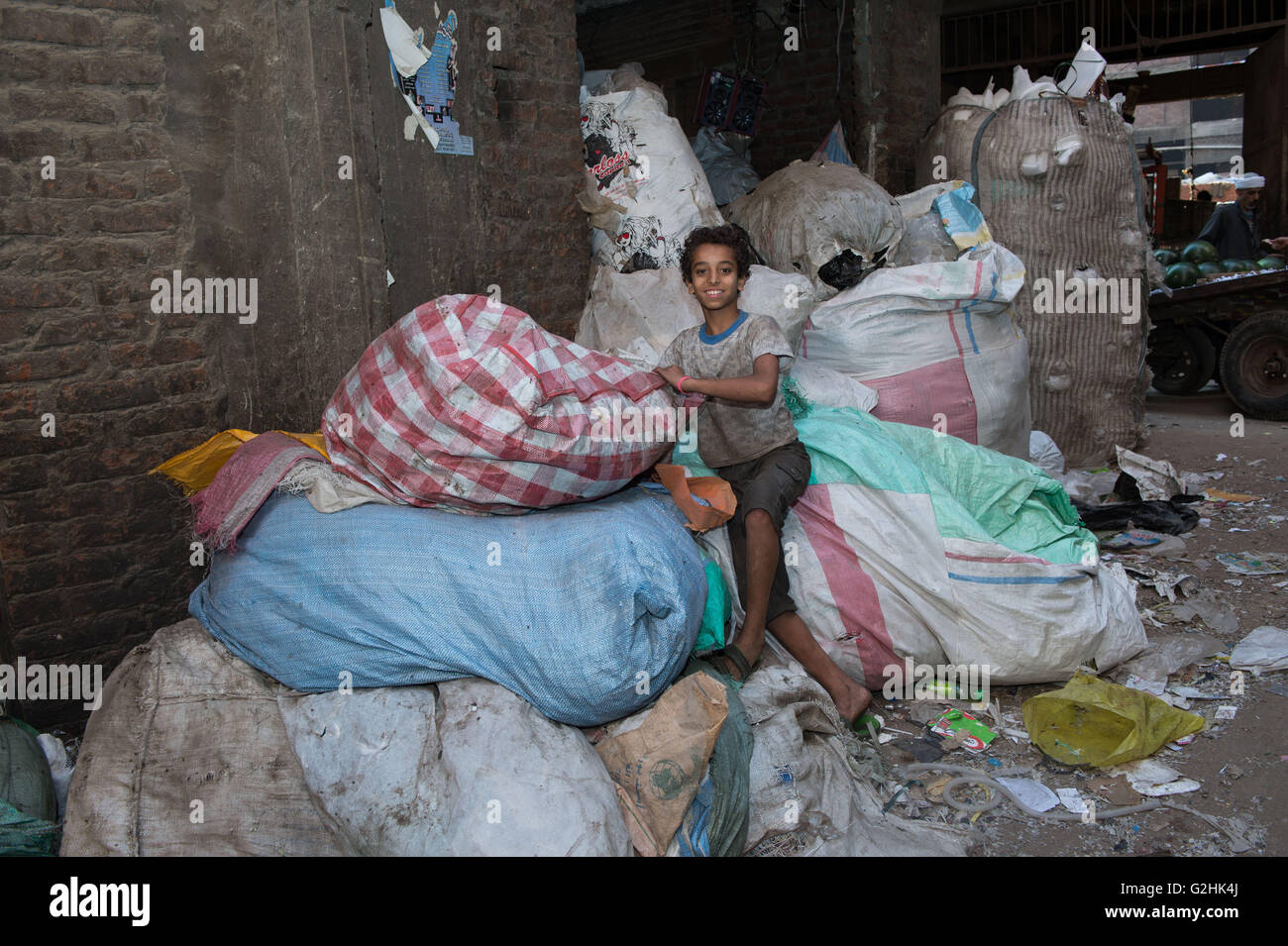 Cairo, Egypt. 27th May, 2016. Thirteen-year-old Steven collects garbage at the Al-Mokattam City, also known as the 'Garbage City', in Cairo, capital of Egypt, on May 27, 2016. Living on the outskirts of Cairo, the Zabalen, which literally means 'garbage people', is a community that has been collecting and recycling Cairo's waste for a long time. They collected and sorted the waste for a living at Al-Mokattam City. The children here live and play among the garbage and lots of them have dropped out of school to help their family's garbage business. © Meng Tao/Xinhua/Alamy Live News Stock Photo