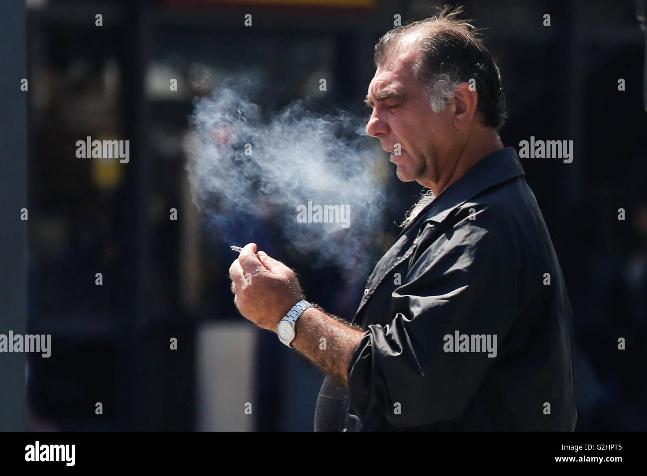 Barcelona, Spain. 31st May, 2016. A man smokes a cigarette in Barcelona