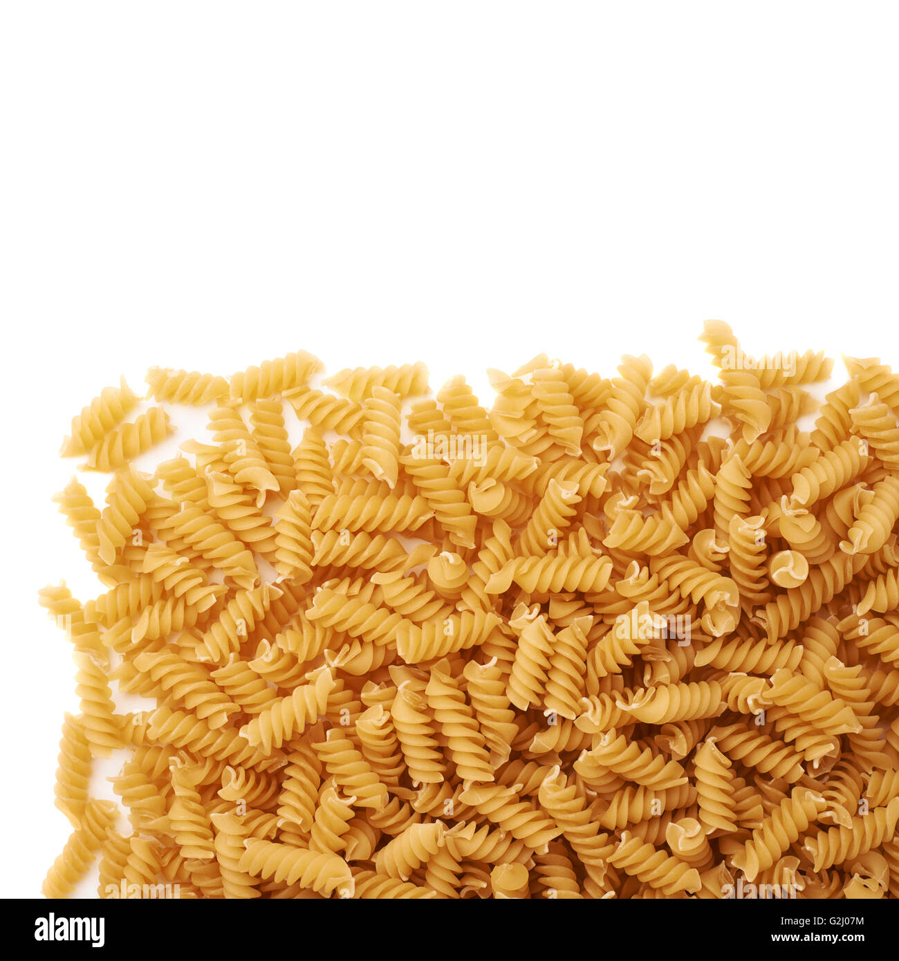 Pile of dry rotini pasta over isolated white background Stock Photo Alamy