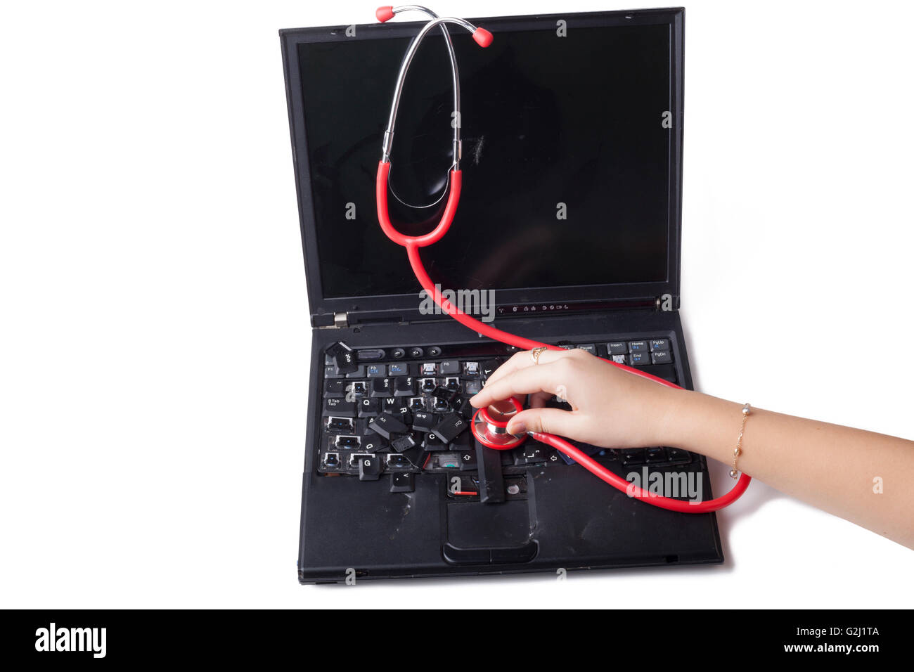 hand holding red stethoscope on broken laptop keyboard solated on white Stock Photo