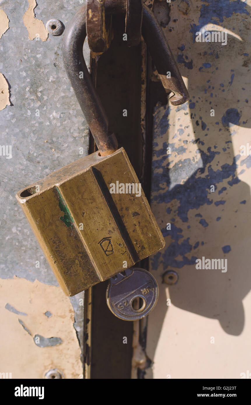 On the old wooden door, installed a rusty padlock Stock Photo - Alamy