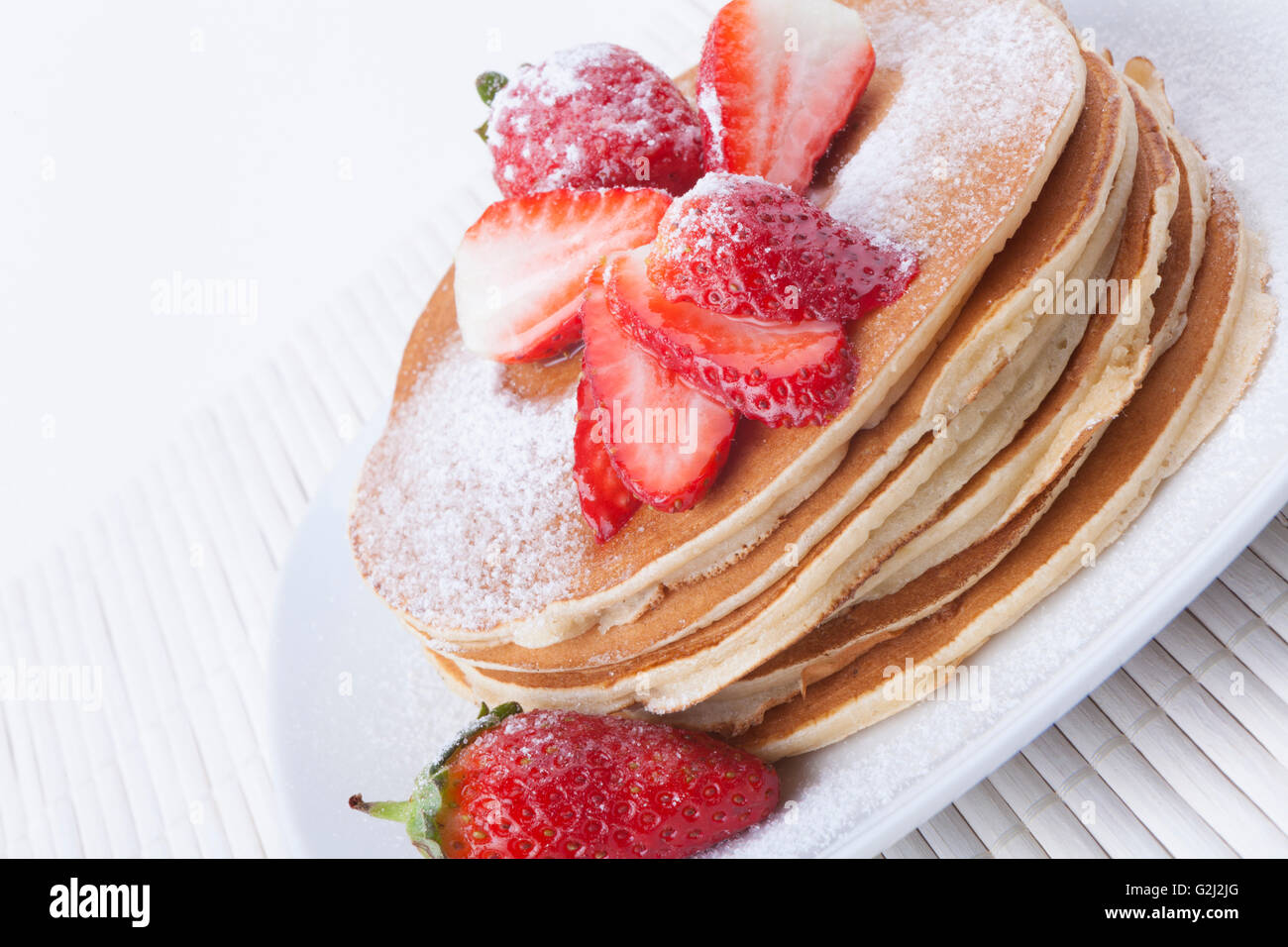 Pancakes with strawberrys and white sugar Stock Photo