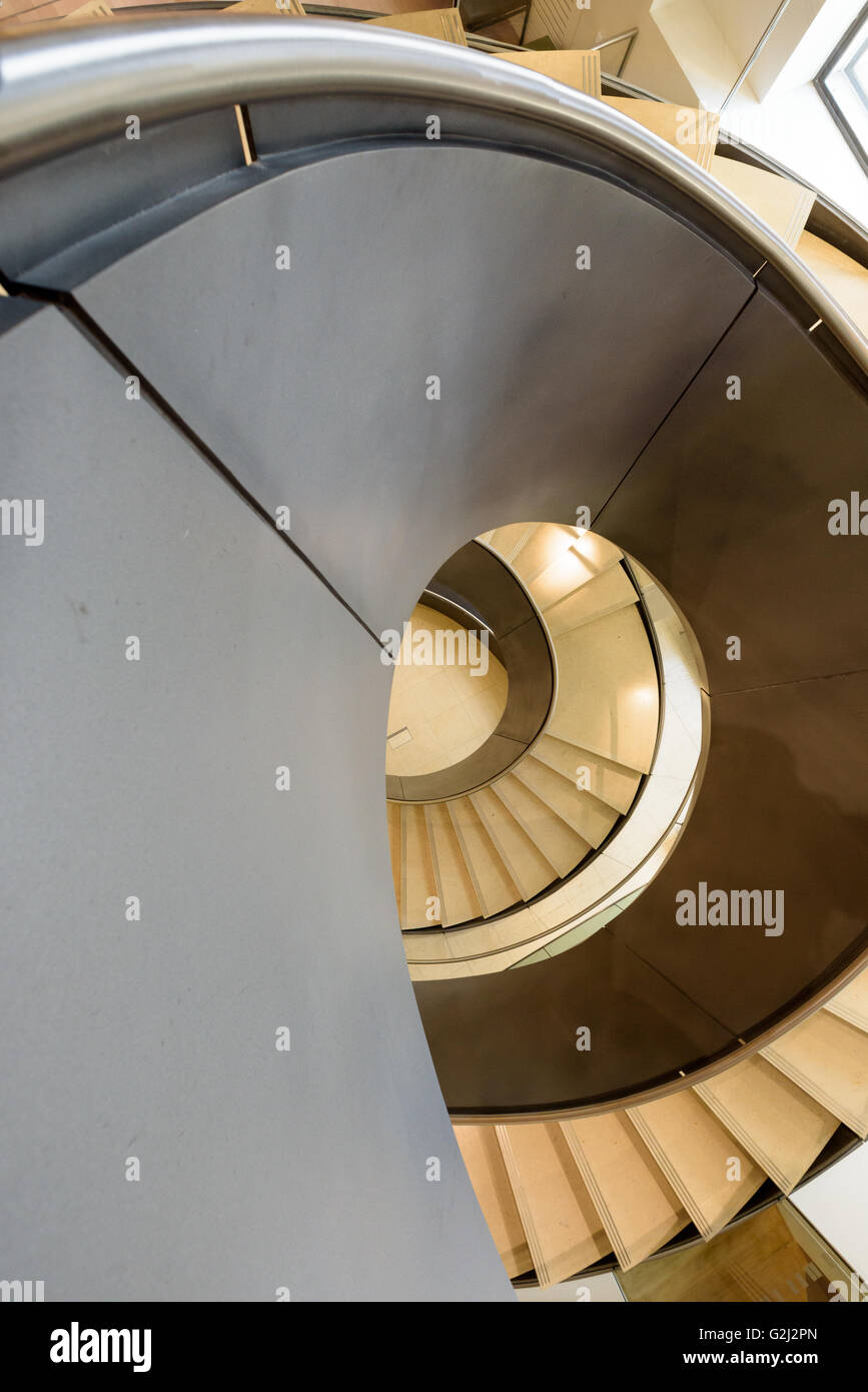 Modern spiral staircase in London at the Wellcome Collection museum at 183 Euston Rd, Kings Cross, London NW1 2BE Stock Photo