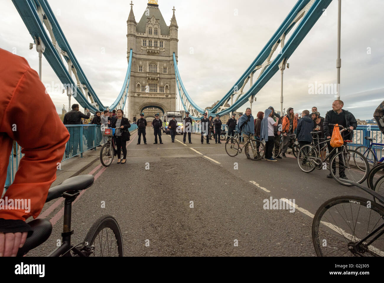 British Police in a line moving across Tower Bridge in London herding a ...
